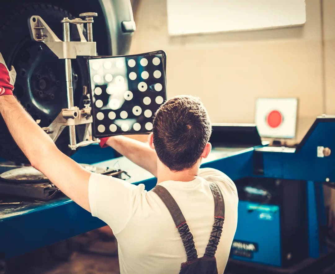 Technician using advanced ADAS calibration frame and targets on vehicle windscreen in professional Melbourne setting