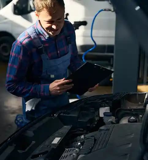 Mechanic using advanced diagnostic tool for ADAS remote programming and technical support in Melbourne workshop