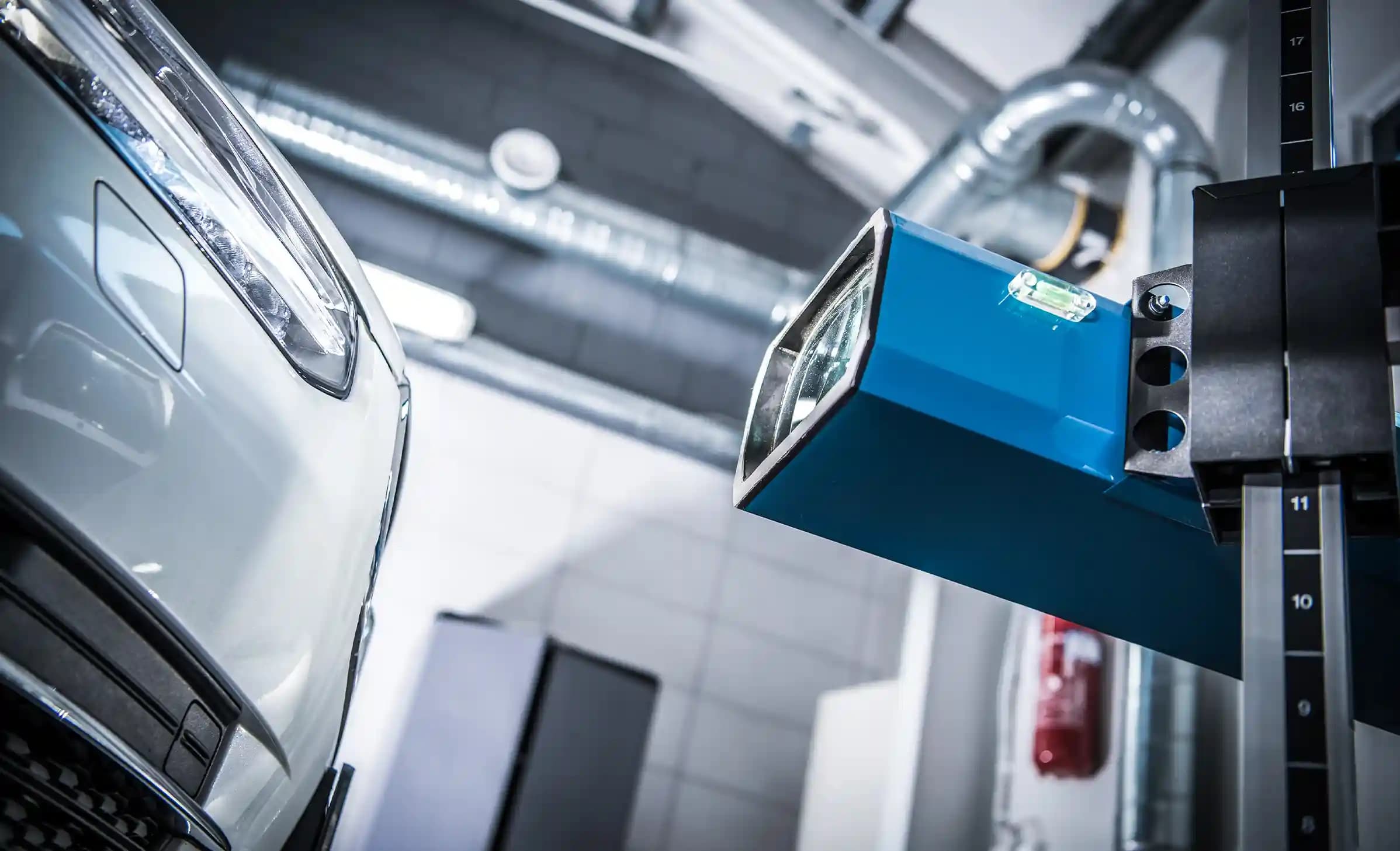  Mechanic conducting ADAS sensor calibration on elevated vehicle in professional Melbourne workshop