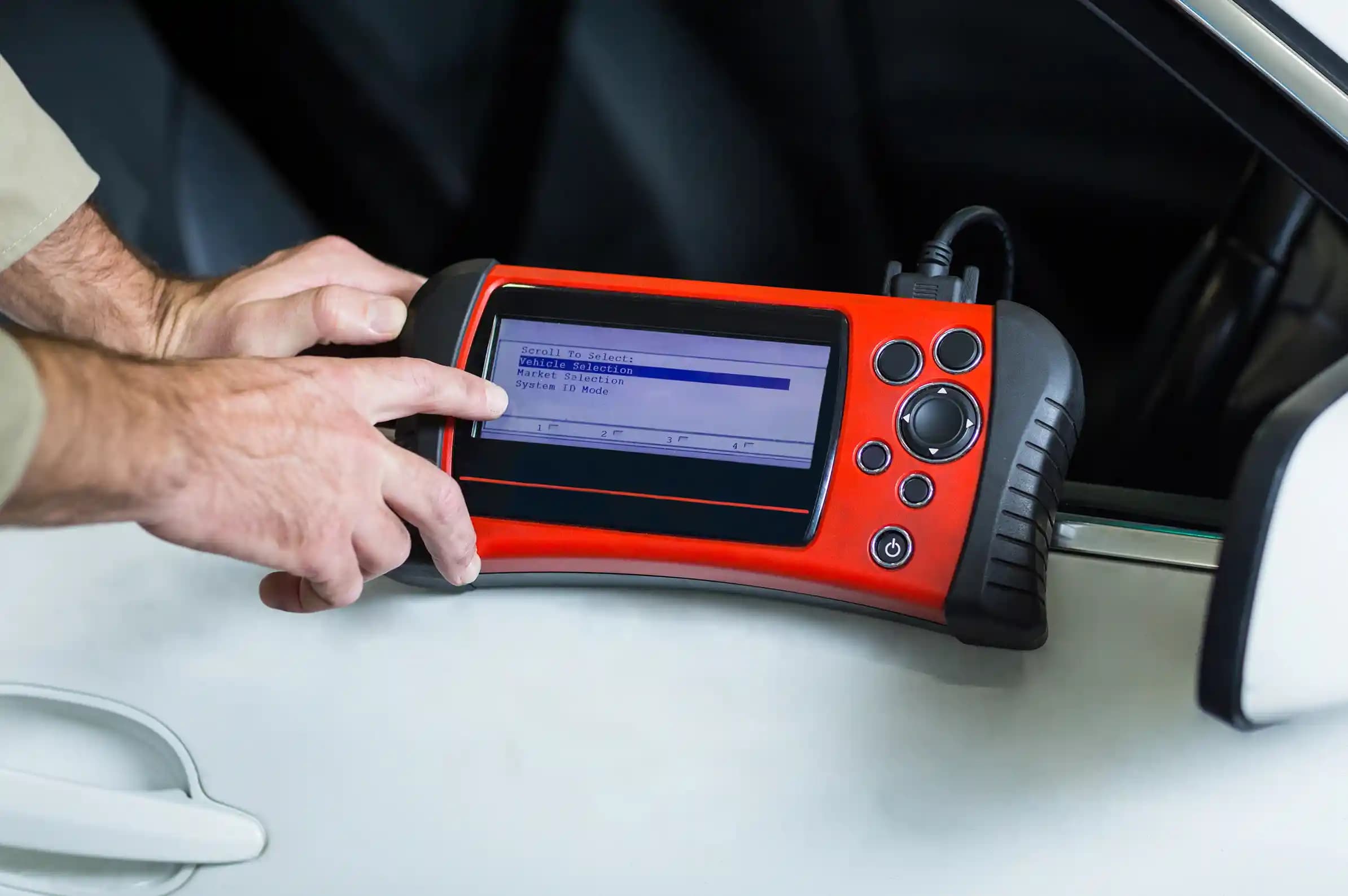 Advanced ADAS fault code diagnostics scanner tool connected to car dashboard for ECU reset and error clearing