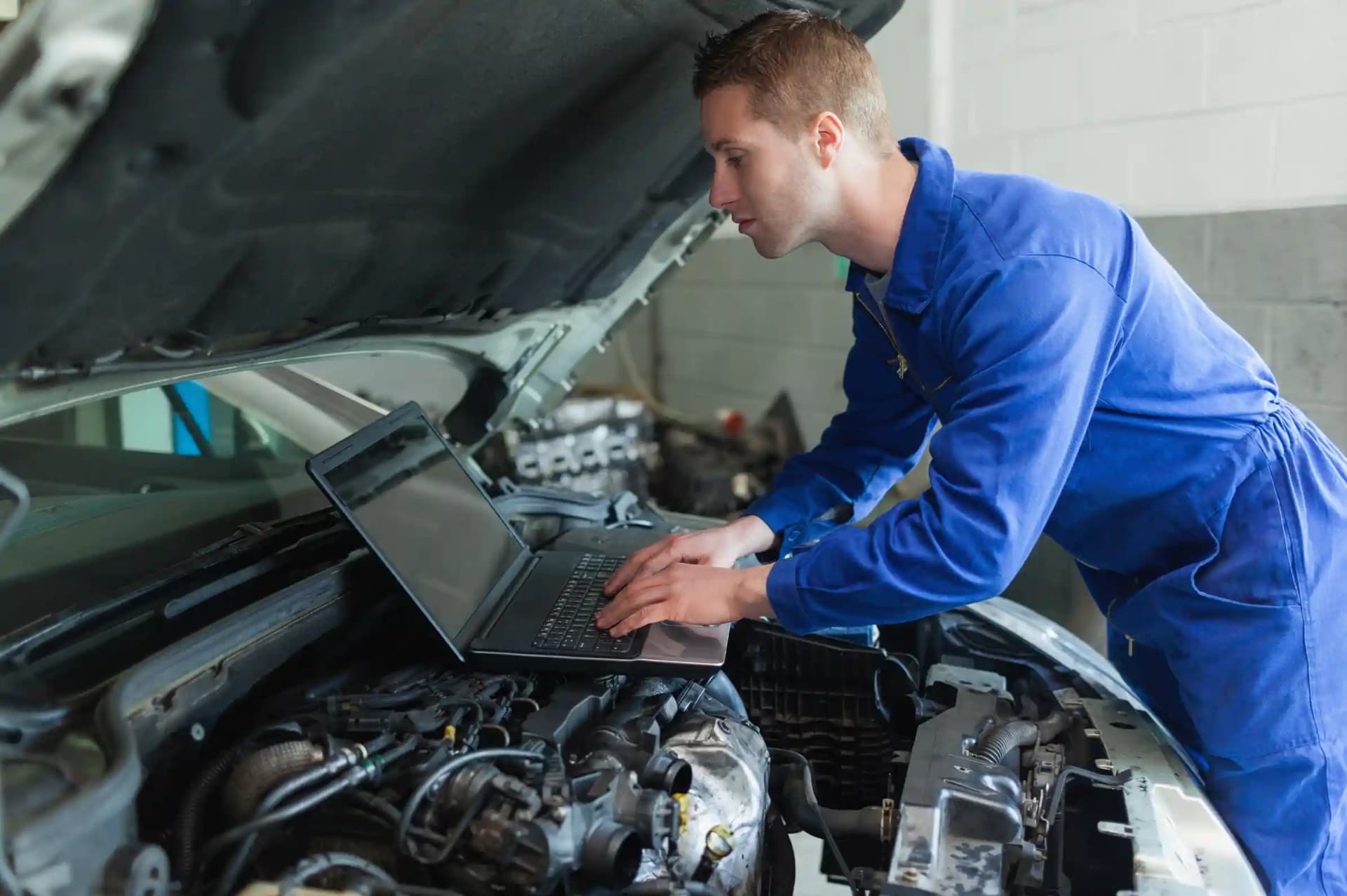 Technician performing OEM coding and programming for ADAS module replacement and feature restoration on vehicle