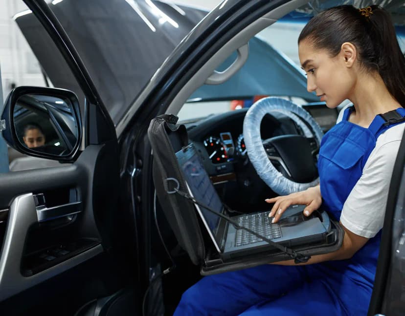 Technician performing ADAS camera calibration on vehicle windscreen in Airport West Melbourne workshop