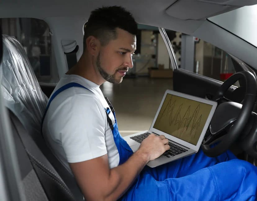 Technician performing ADAS camera calibration on vehicle windscreen in Broadmeadows Melbourne workshop