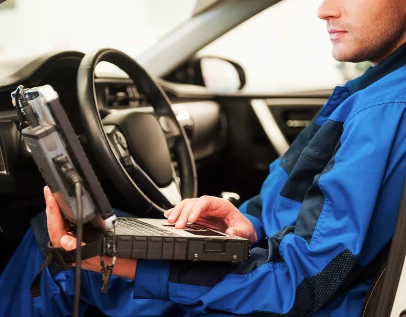 Technician performing ADAS camera calibration on vehicle windscreen in Craigieburn Melbourne workshop
