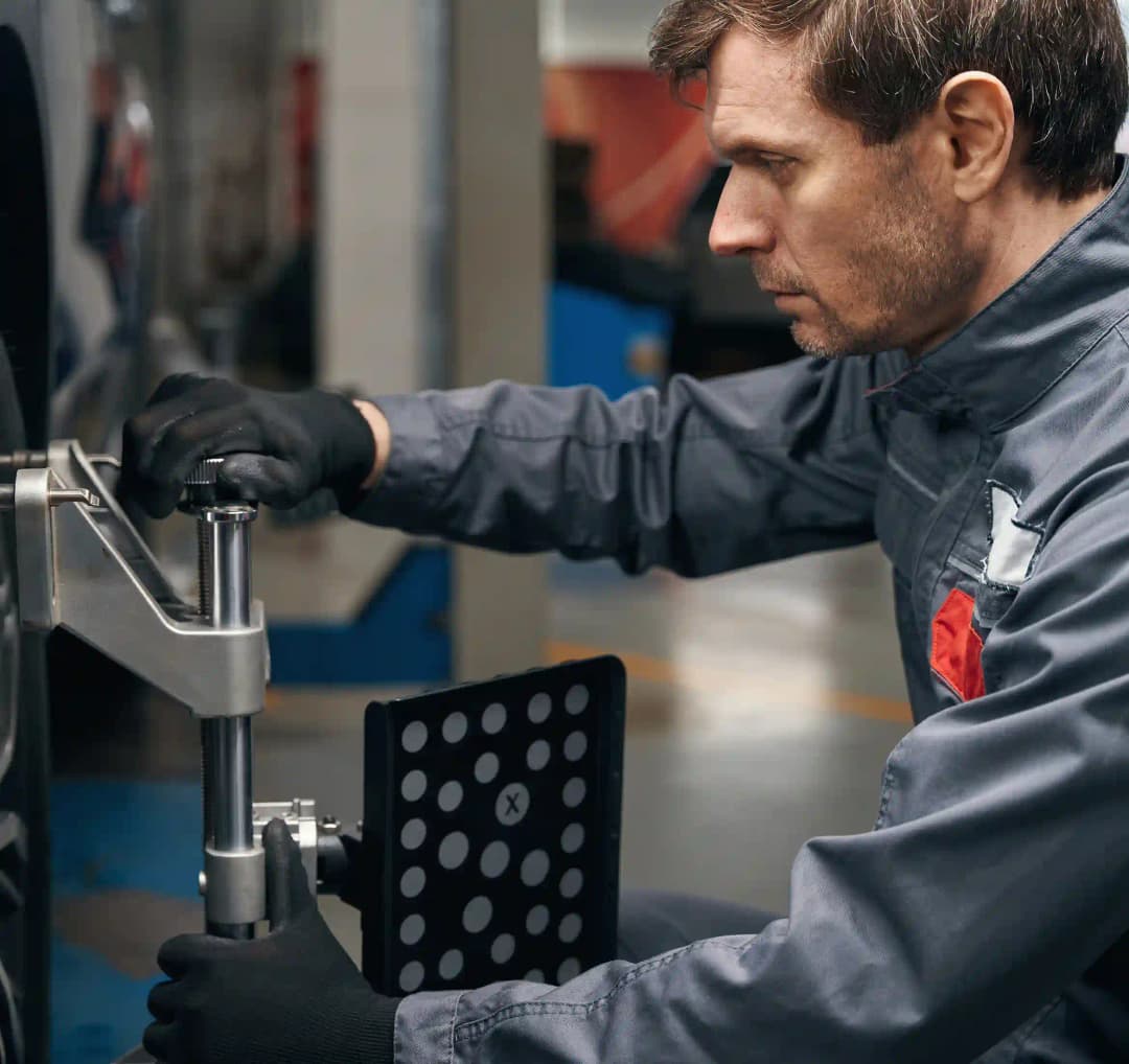 ADAS technician using diagnostic tools on vehicle in Essendon workshop for precise calibration