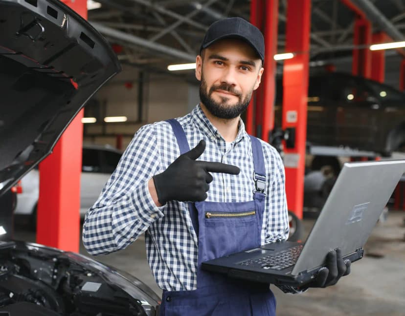 Technician performing ADAS camera calibration on vehicle windscreen in Melbourne Airport Melbourne workshop