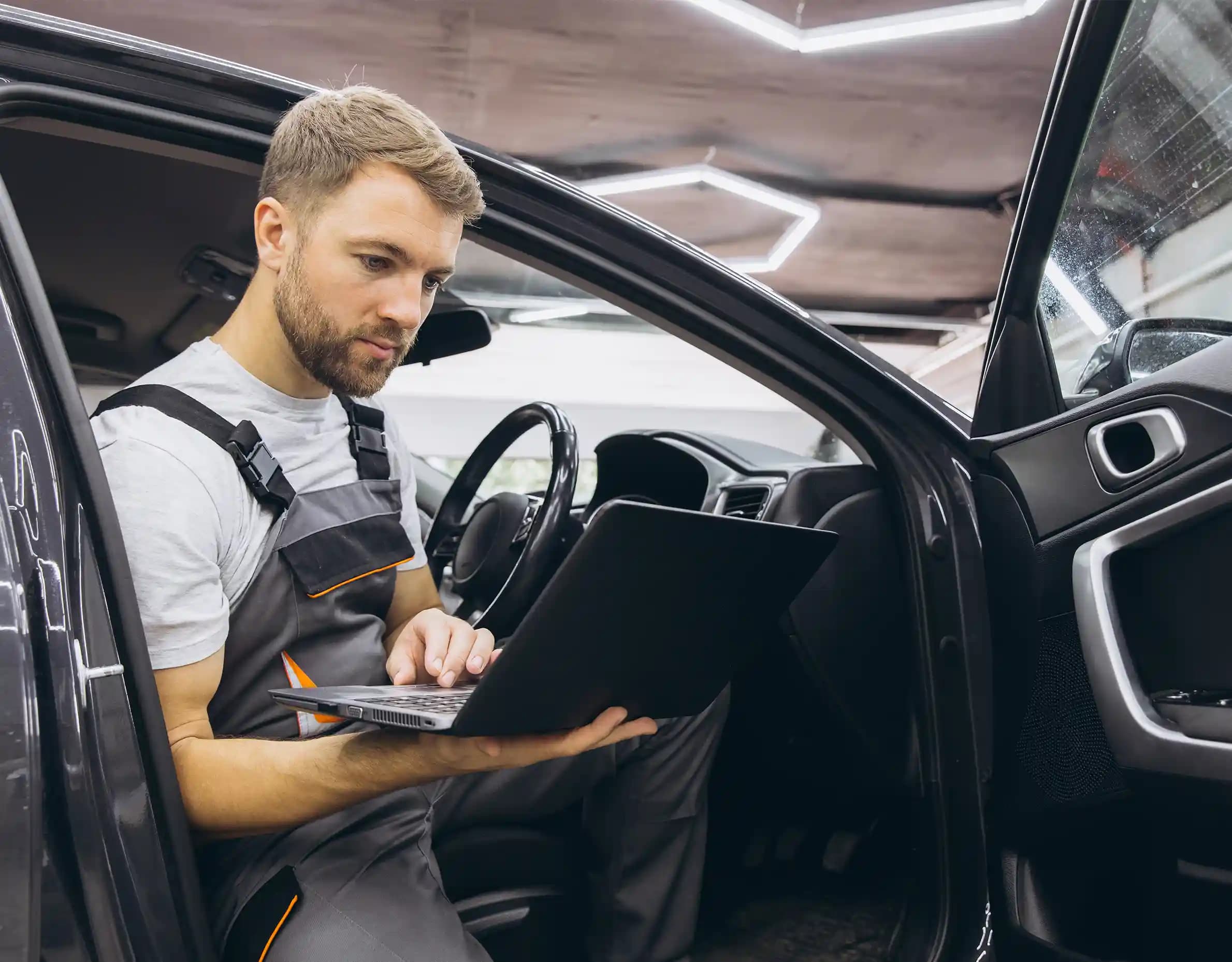 Technician performing ADAS camera calibration on vehicle windscreen in Sunshine Melbourne workshop
