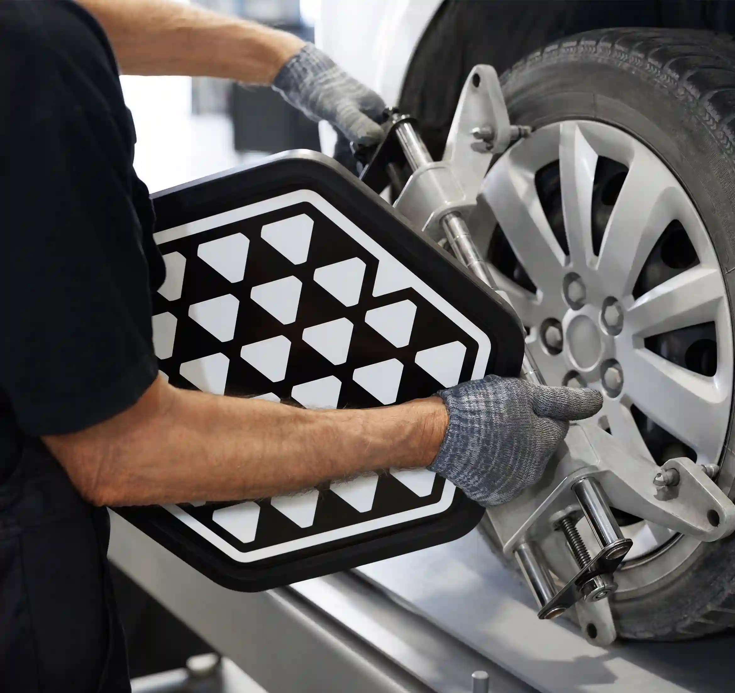 ADAS technician using diagnostic tools on vehicle in Sunshine workshop for precise calibration