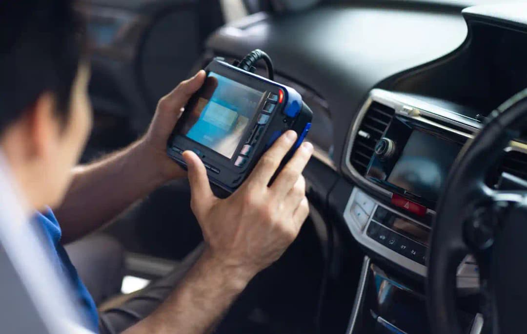 Close-up of vehicle dashboard during lane assist camera calibration and forward camera recalibration