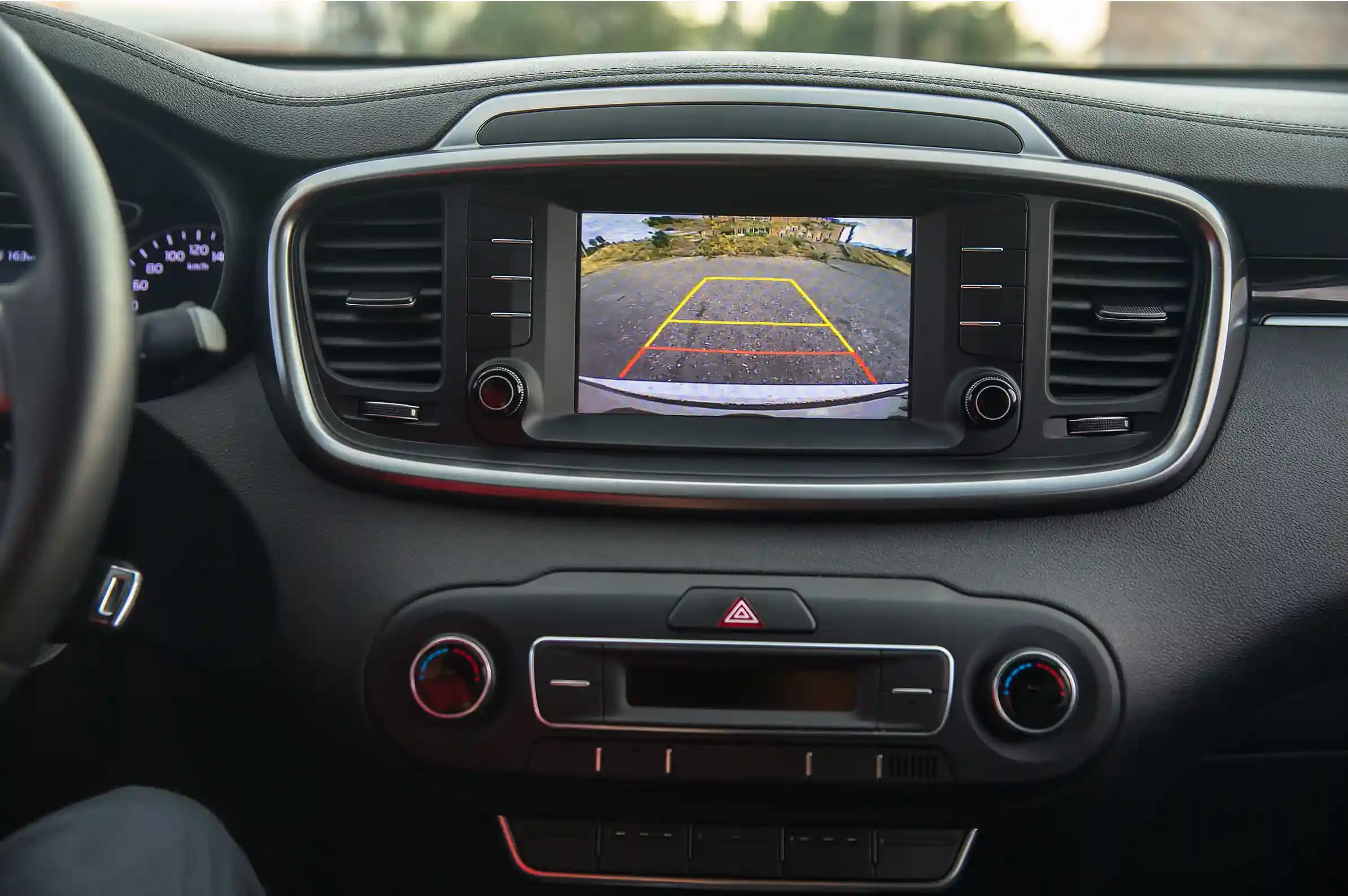 Technician performing ADAS camera calibration on vehicle windscreen with precision targets in Melbourne workshop