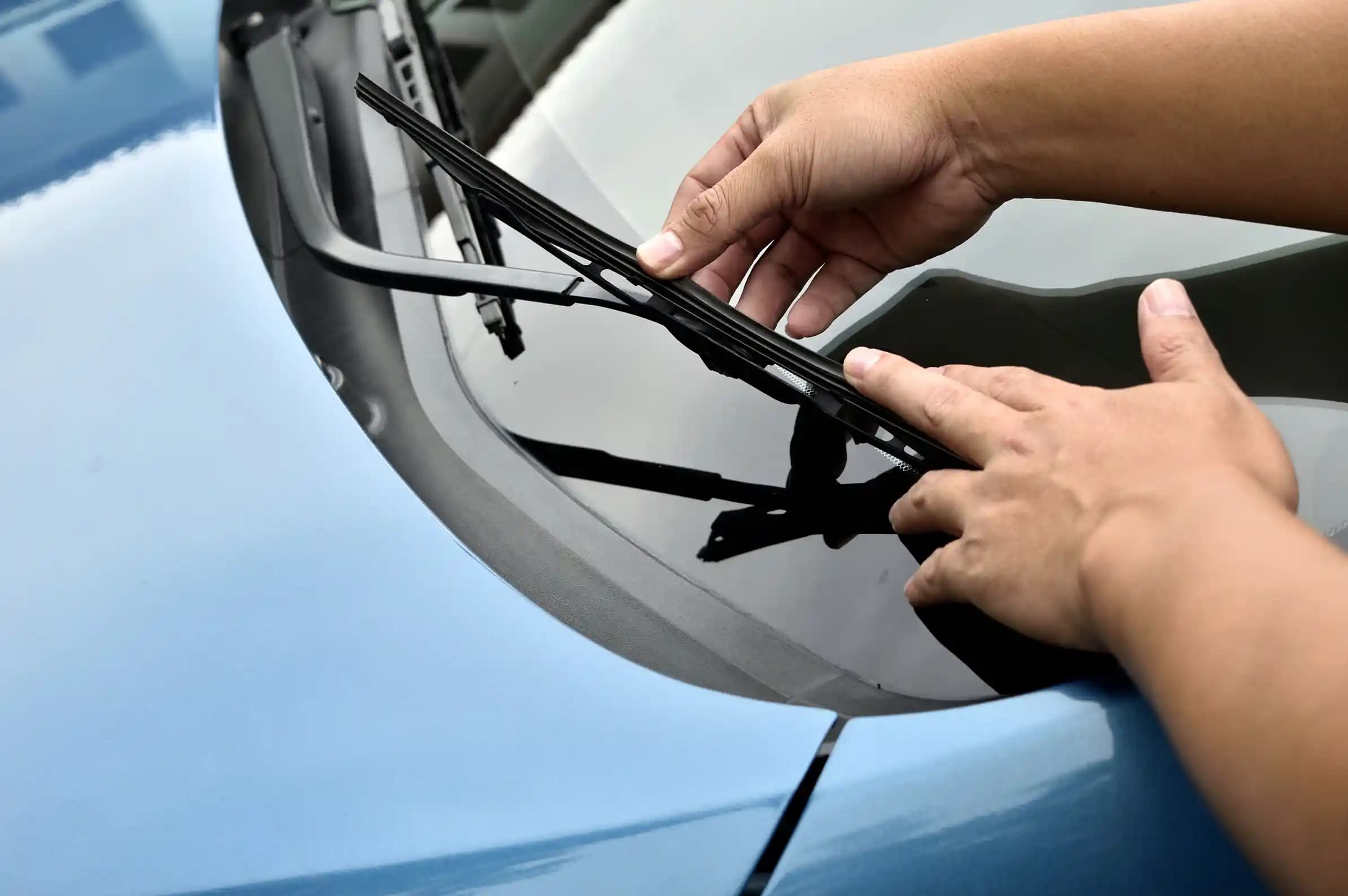 ADAS recalibration after windscreen replacement technician adjusting camera and sensors for safety system accuracy