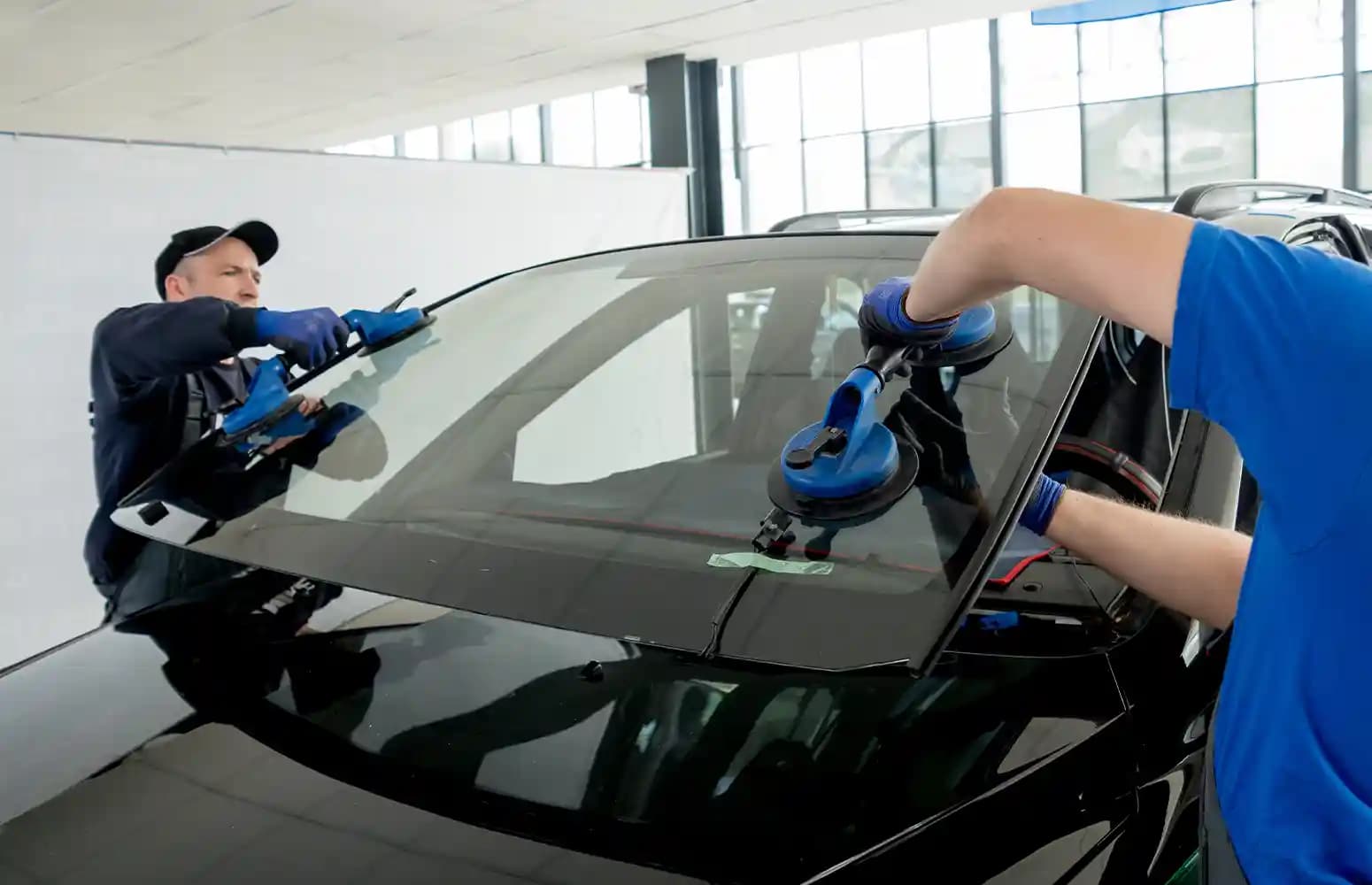 Technicians performing windscreen ADAS camera calibration in Melbourne workshop after replacement